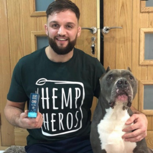 Hemp heros: A man wearing a black t-shirt stands next to a dog