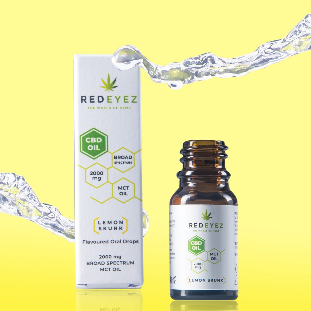 Red Eyez: A bottle of CBD oil against a yellow background. The bottle is next to the white box 