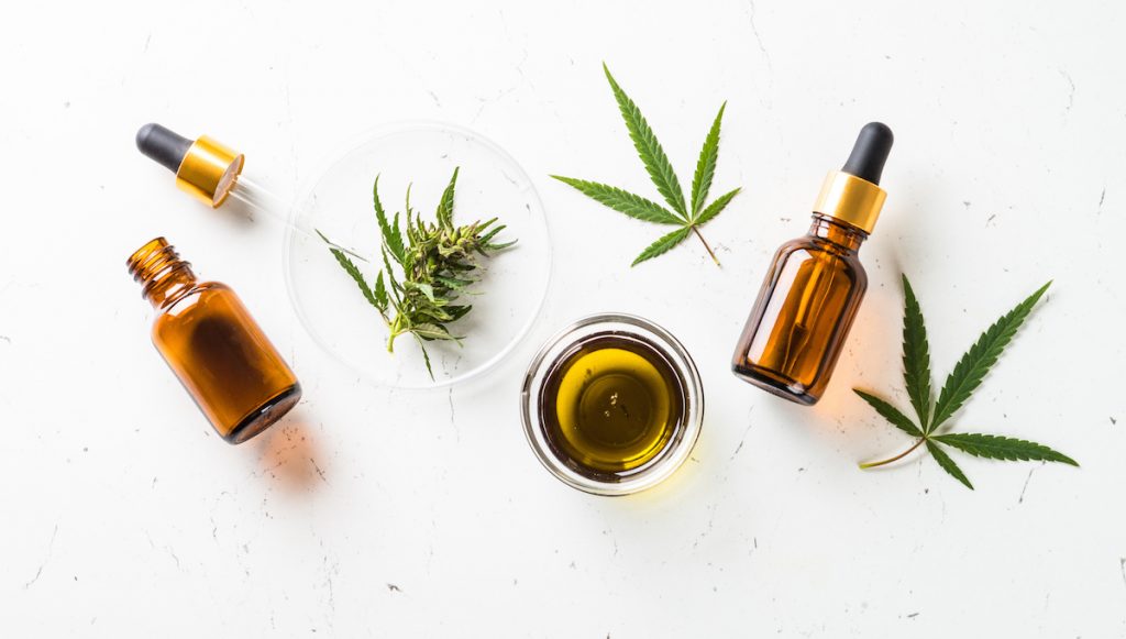 Depression: A collection of CBD bottles and cannabis leaves on a white background