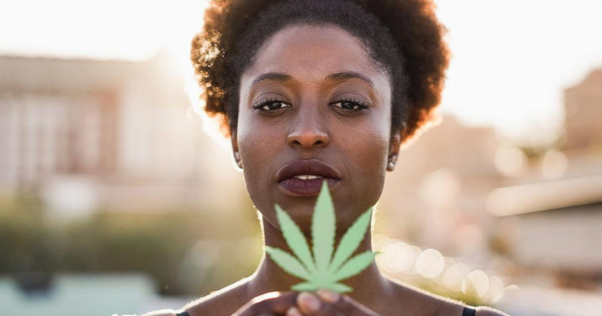 Africa: A woman holding a cannabis leaf