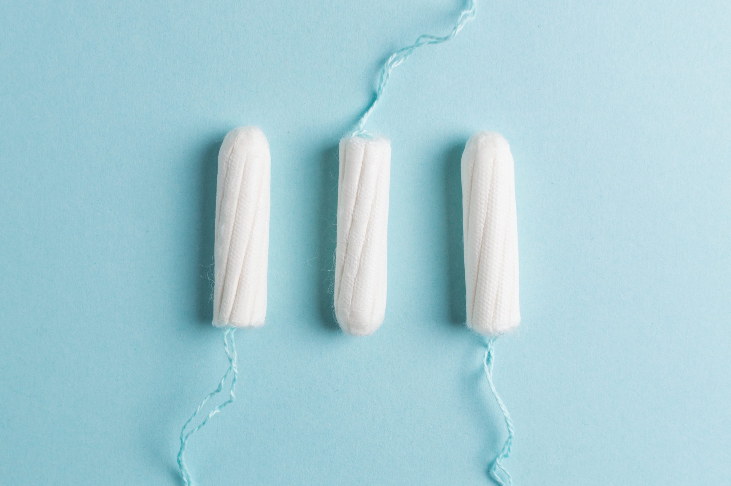 Periods: A row of tampons on a blue background