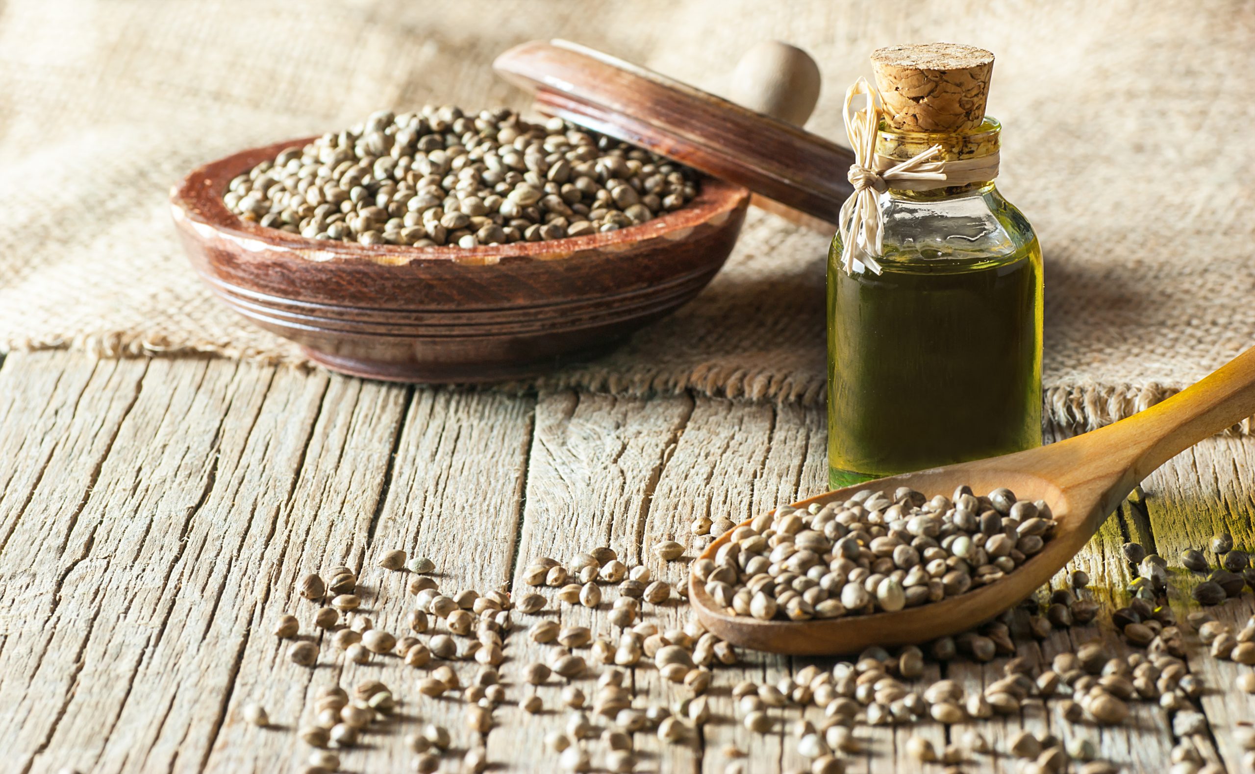 Hemp: A bowl of hemp seeds with a small bottle of oil beside it